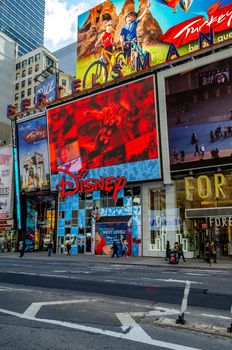 Disney Store Building Exterior at Time Square New York during daytime, view from the other side of the Street, People walking in forefront, no Cars on the street, vertical