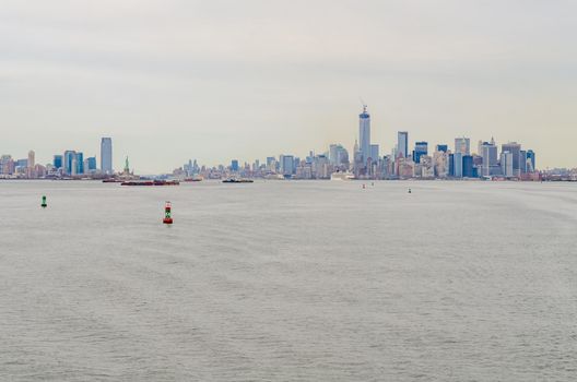 New York City Manhattan and Jersey City Skyline aerial view with Hudson river in the forefront, during winter day with overcast, horizontal