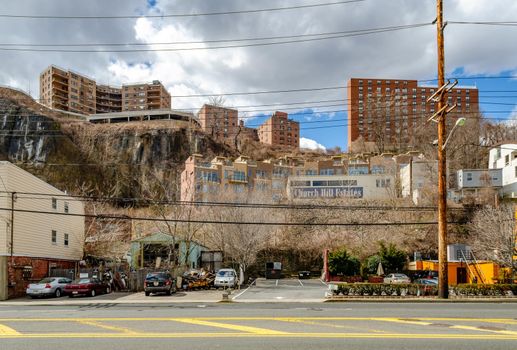 Church Hill Estates Building with residential Building Skyscraper on a rock on top of the hill, North Bergen, New Jersey, during a sunny winter day, road in the forefront, horizontal