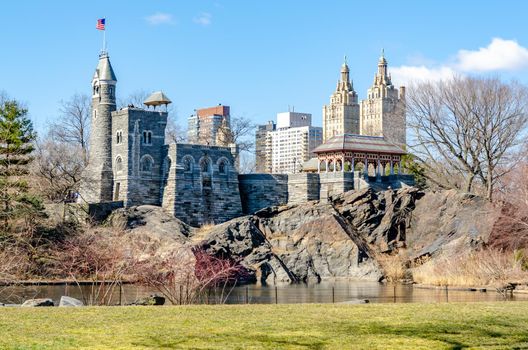 Belvedere Castle Central Park New York during winter with clear sky view from the distance with lake and meadow in the forefront, horizontal