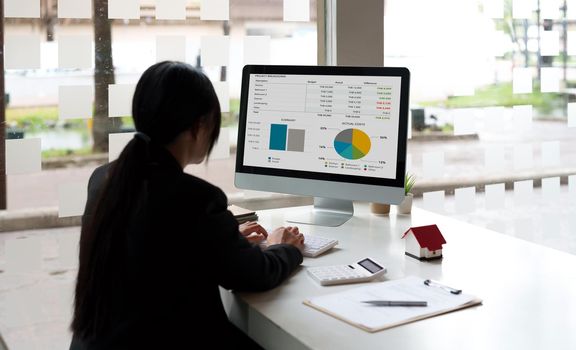 Close up real estate business woman working with pc computer for financial accounting