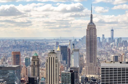 Empire State Building Aerial View with One World Trade Center construction site in the background, New York City during winter, horizontal