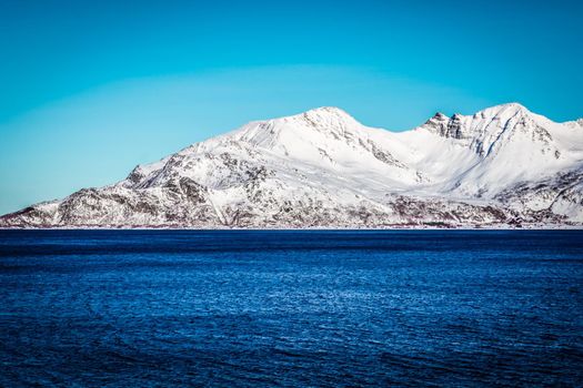 Snow Mountain with Fjord in foreground (Norway near Tromso)