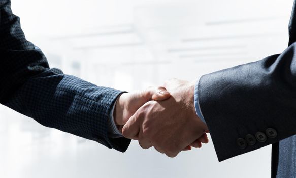 A close-up of a handshake. Making a deal between two businessmen