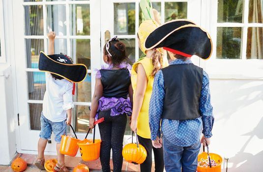 Shot of a group of unrecognizable little children going trick-or-treating.