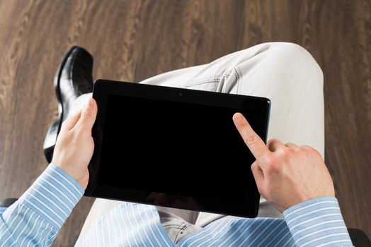 close-up of men's hands with a computer tablet. Businessman works in the office