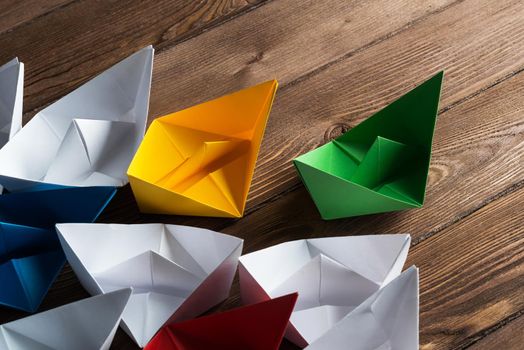 Set of origami boats on wooden table