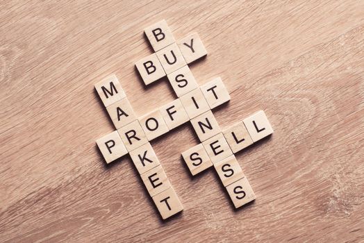 Words of business marketing collected in crossword with wooden cubes