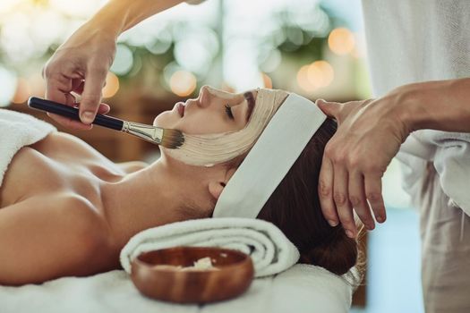 Shot of an attractive young woman getting a facial at a beauty spa.