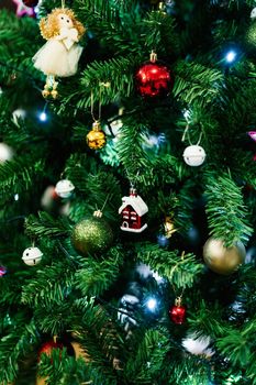 Close-up photo of a New Year tree decorated with toys, lights and balls. High quality photo