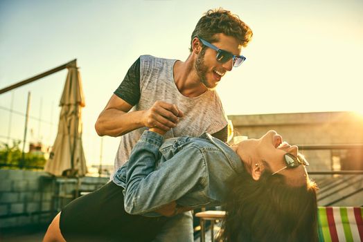 Shot of an affectionate young couple dancing together outdoors.