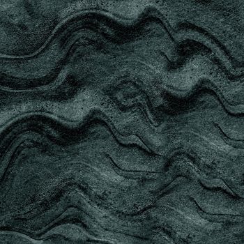 Wave pattern of a dark gray stone structure close-up
