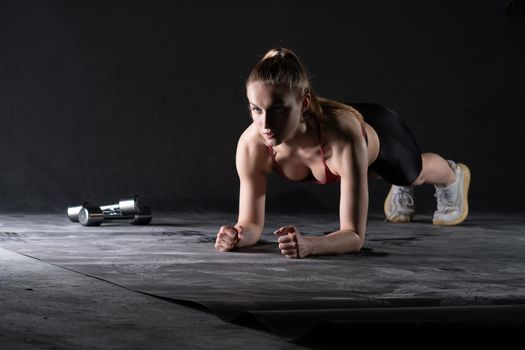 The girl on in the dumbbells plank stands a with floor push-ups looks like a kira knightley girl fitness black, for caucasian female in young from healthy bodybuilding, dumbbell sexy. Wellness