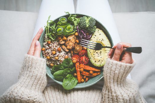 Woman holding plate with tasty vegan or vegetarian food. Healthy vegan meal. Vegan buddha bowl with healthy food. Healthy eating or diet. High quality photo