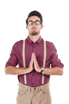 Studio shot of a young man meditating against a white background.