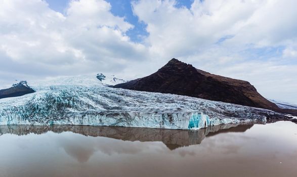 Glacier lake panorama with massive glaciar tongue end in Iceland