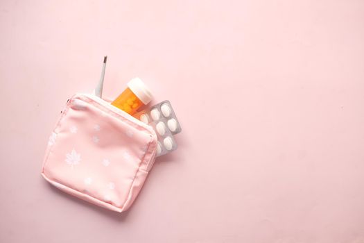 medical pill container, blister pack and thermometer in a small bag ,