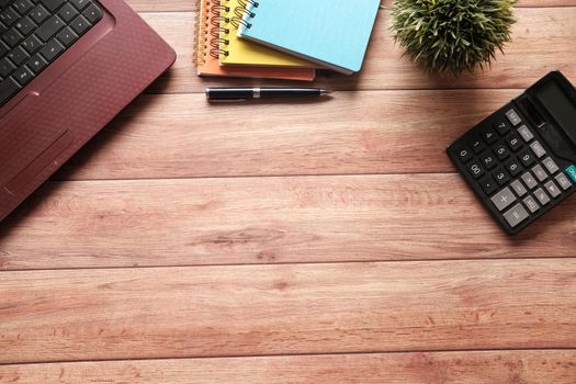 modern office desk with laptop and office stationary on table