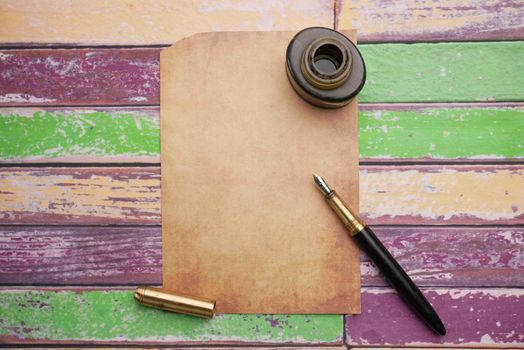 old empty paper and fountain pen on table .