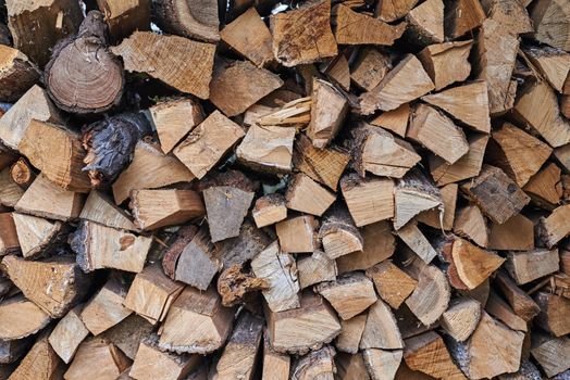 Stack of firewood as background. Pile of chopped wood, close up