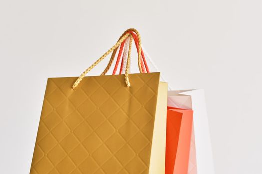 colorful paper shopping bag on white background, close up