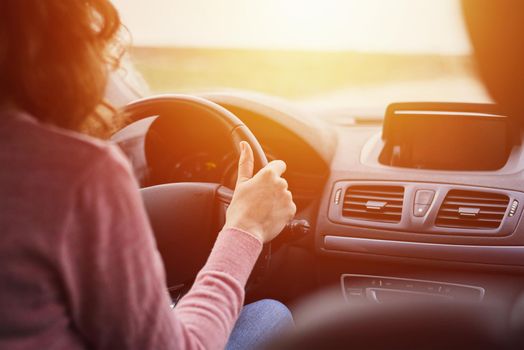 Close up of woman driving a car, back view