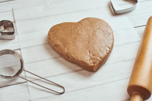 raw dough in shape of heart on table