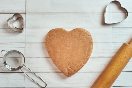 raw dough in shape of heart on table