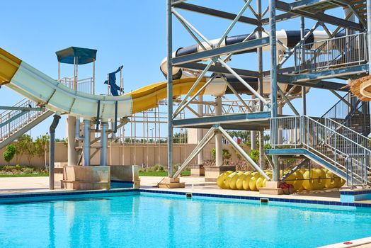 Close up of tube water slide in aqua park against blue sky