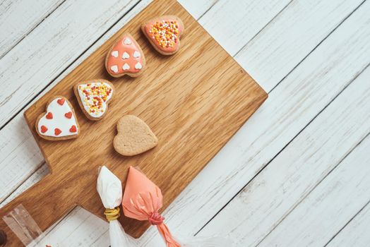 Decorated gingerbread cookies with icing on table