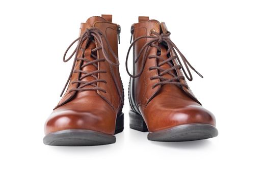 Pair of brown leather womens boots on white background isolated