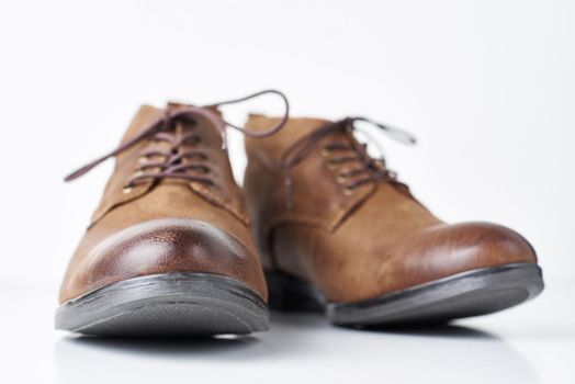 Pair of brown leather womens boots on white background isolated