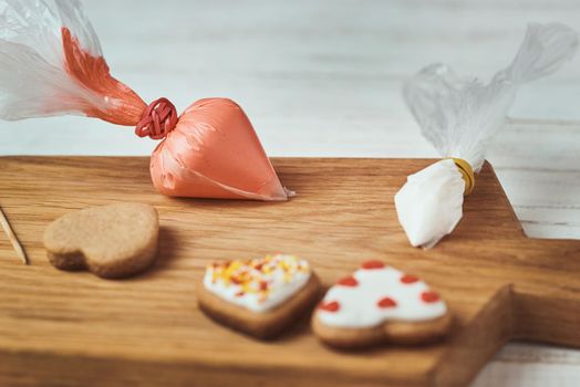 Decorated gingerbread cookies with icing on table