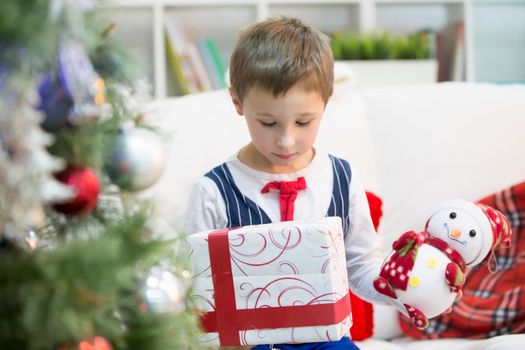 A boy with a Christmas gift.Get a gift for Christmas. The child received a gift