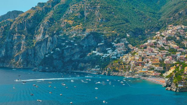 One of the best resorts of Italy with old colorful villas on the steep slope, nice beach, numerous yachts and boats in harbor and medieval towers along the coast, Positano