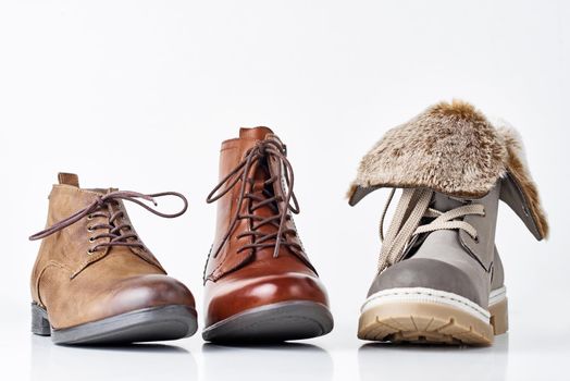 Three different leather womens boots on white background isolated