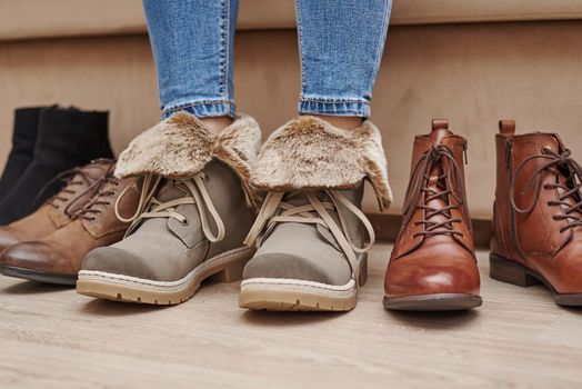 Woman chooses comfortable shoes among bunch of different pairs