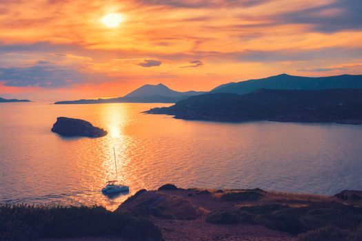 Aegean Sea with Greek islands view on sunset with yacht in sea. Cape Sounion, Greece