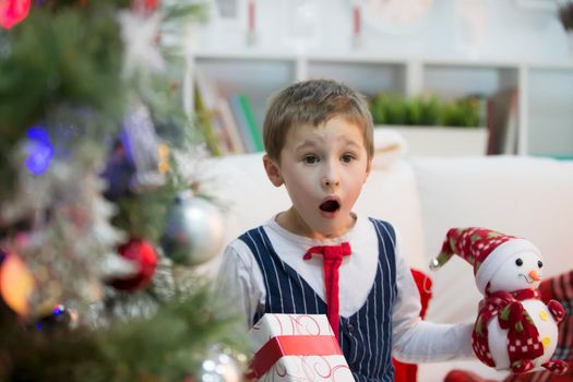 A boy with a Christmas gift.Get a gift for Christmas. The child received a gift