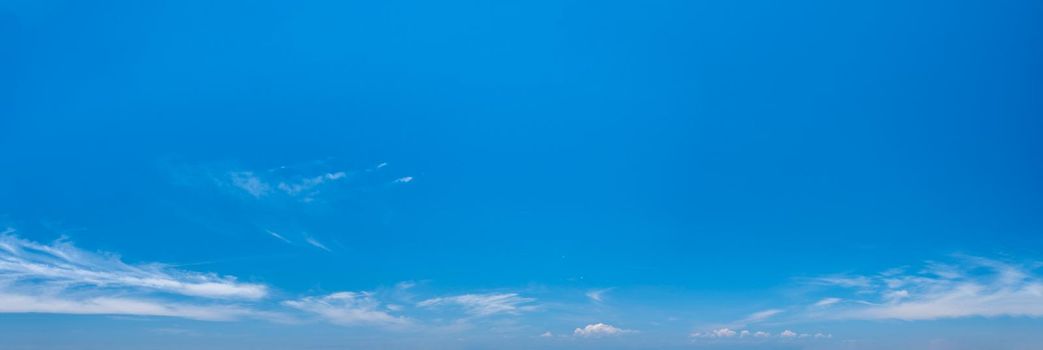 Panorama of summer blue sky with rare clouds