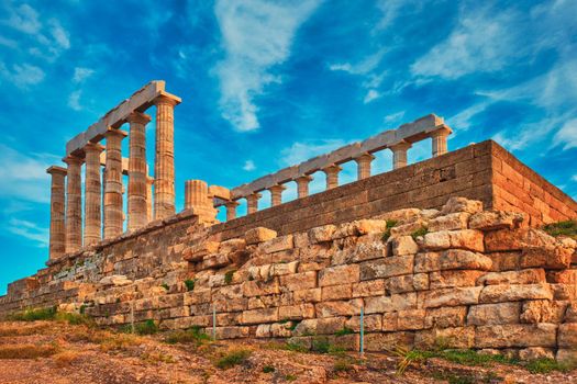 Greece Cape Sounio. Ruins of an ancient temple of Poseidon, Greek god of the sea, on sunset. Shot of temple ruins on sunset. Tourist landmark of Attica, Sounion, Greece