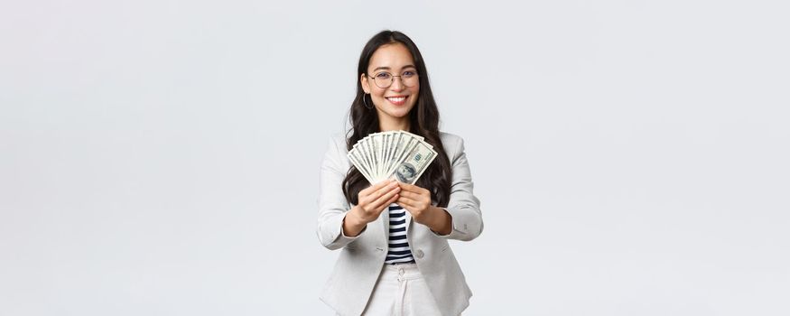 Business, finance and employment, entrepreneur and money concept. Businesswoman giving you cash, suggest good work with stable big income, smiling inviting for job in her company.