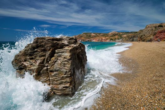 Rocks on Paleochori beach and waves of Aegean sea, Milos island, Cyclades, Greece. Slow motion