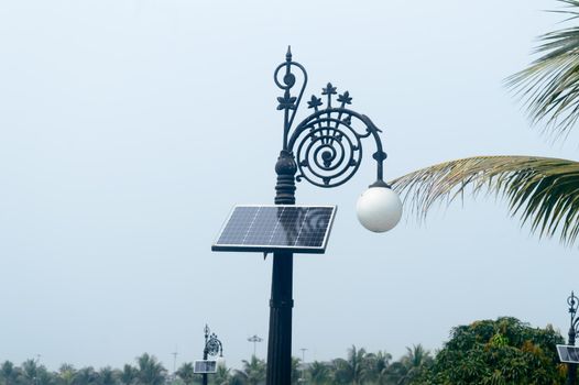 Classic Aesthetic Decorative Solar LED Lamp Post Light against blue sky background. Its solar powered, and come on automatically at dusk and turn off at dawn to recharge in the sun.