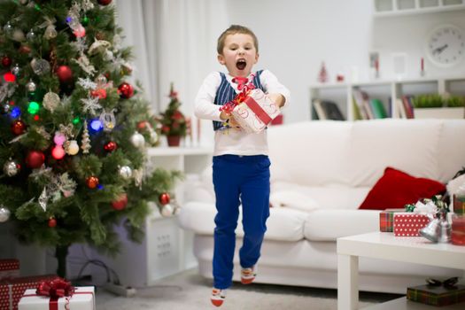 A boy with a New Year's gift. Happiness is Christmas.