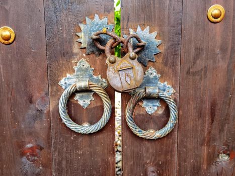 An old wooden door locked with a vintage padlock. True vintage style