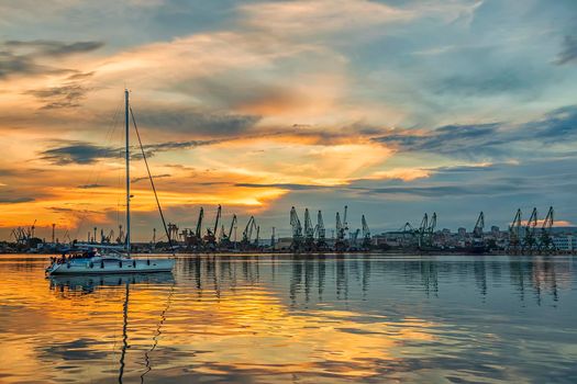 Yacht coming a port at a stunning sunset