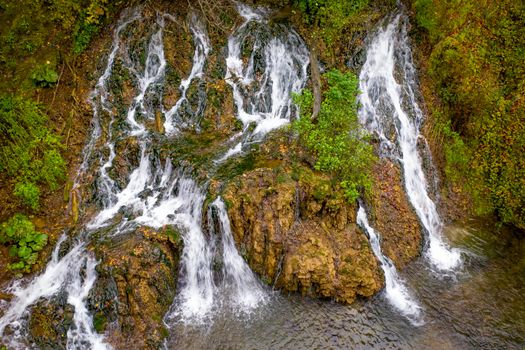 Waterfall in nature. Mountain cascade river waterfall. Aerial drone view