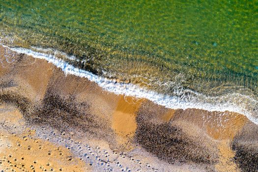 Aerial top view from drone to the seacoast with waves