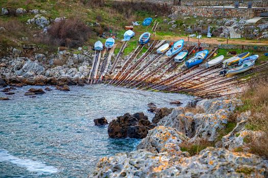 The pier of the Bulgarian village of Tyulenovo on the northern seaside with fishing boats on the shore